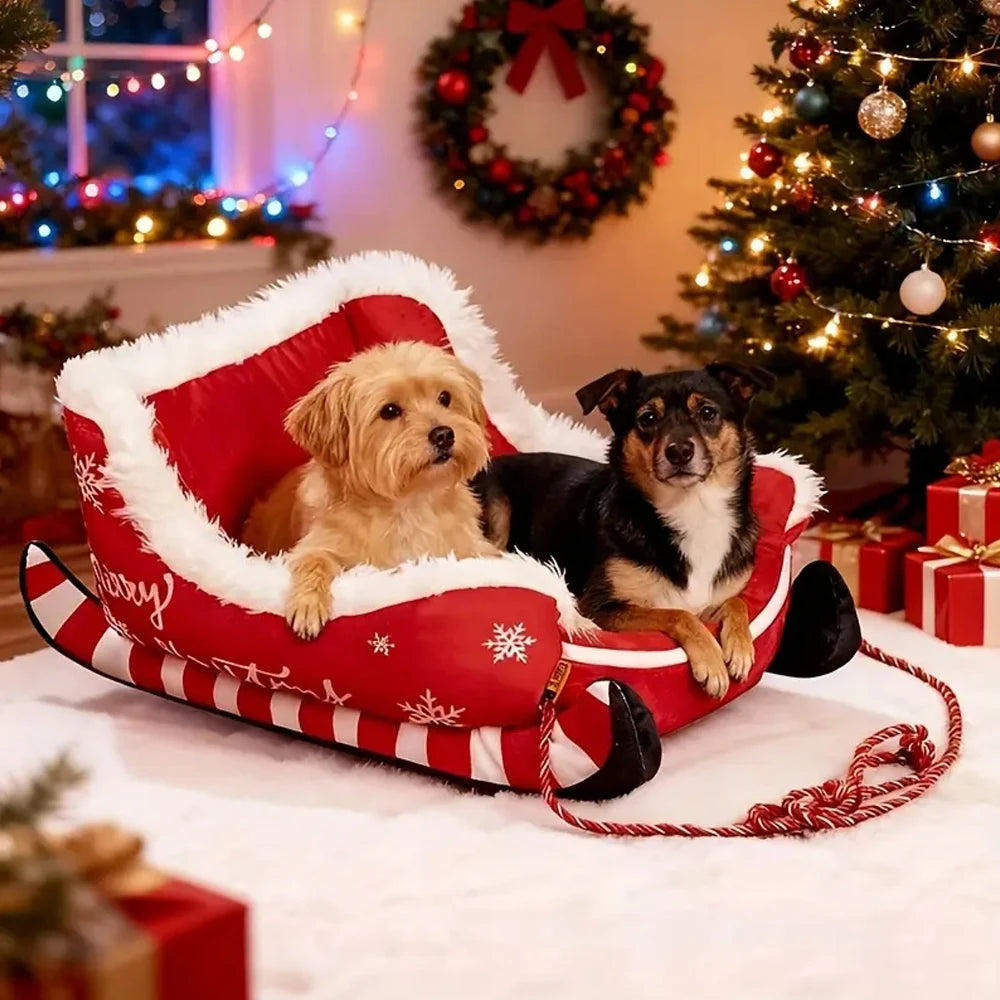Two dogs in a red and white Christmas-themed pet bed with a decorated tree and wreath in the background.