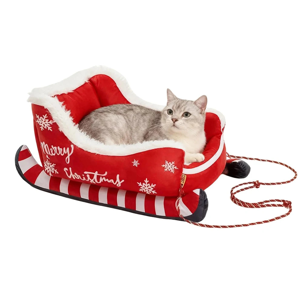 Cat lying in a red and white Christmas-themed pet bed with a leash.