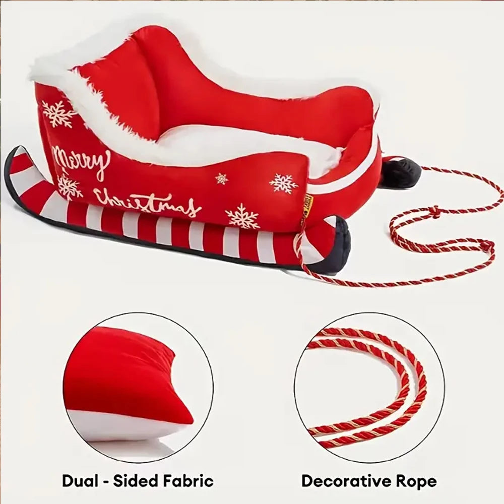 Red Christmas-themed inflatable sleigh with dual-sided fabric and decorative rope on a white background.